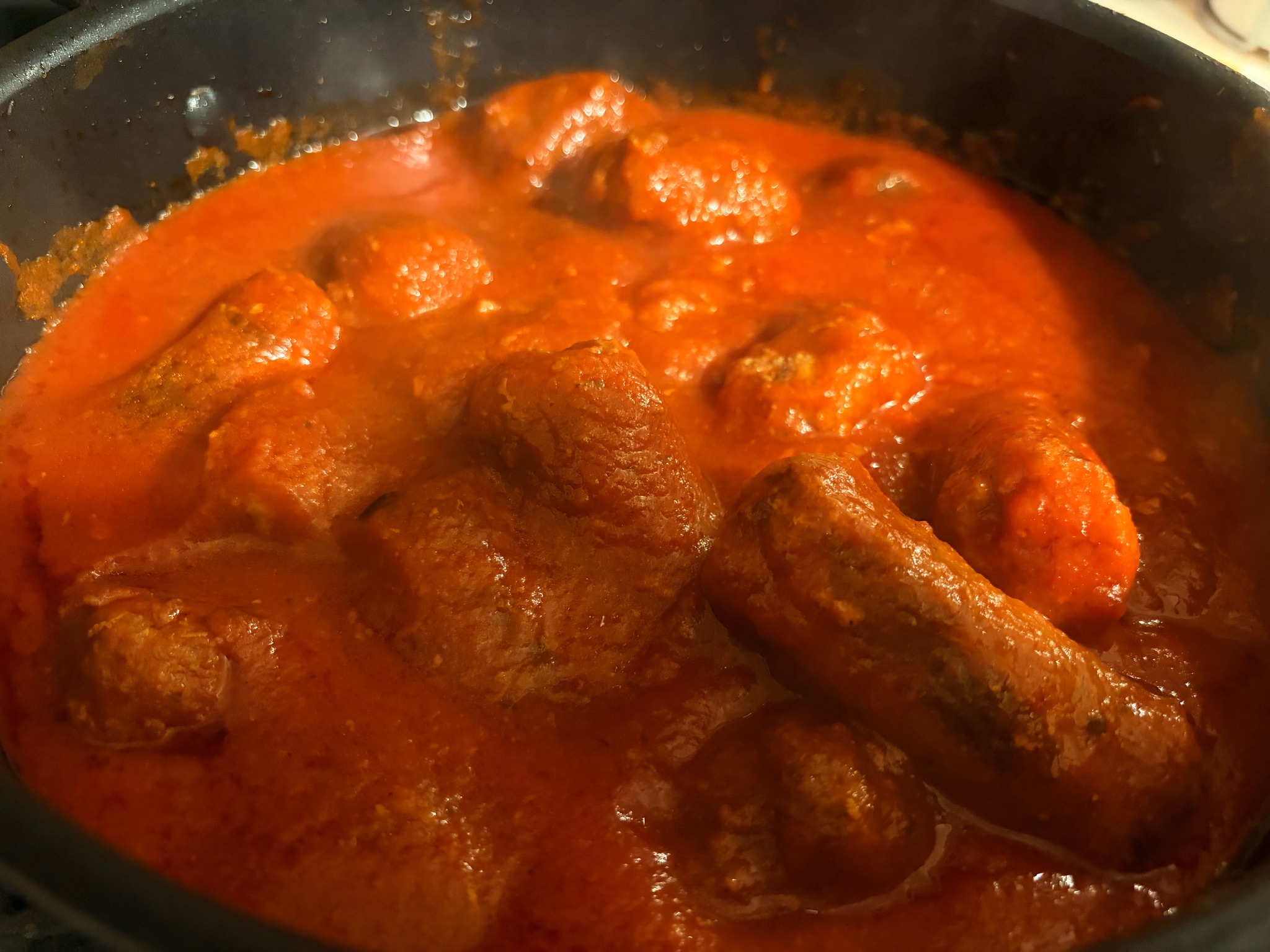 Meatballs and hot Italian sausage in homemade red sauce